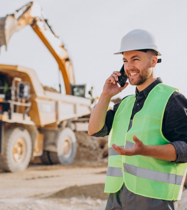 Male worker with bulldozer in sand quarry